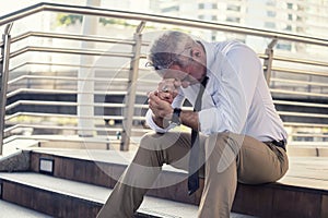 Anxious old businessman in city