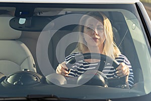 Anxious scared woman driver worried looking at car accident on road through windshield drive vehicle