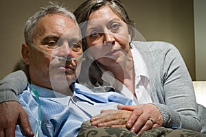 Anxious senior wife holding her sick husband