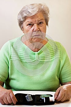 Anxious senior woman with blood sugar test