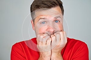 Anxious stressed young man looking at camera. He has paranoia or mental problems