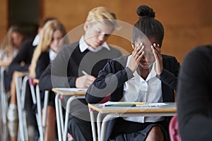 Anxious Teenage Student Sitting Examination In School Hall