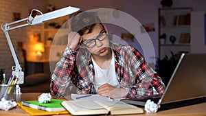 Anxious teenager student trying to solve difficult math assignment, problems