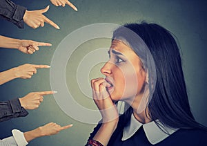Anxious woman judged by different hands. Accusation of guilty girl