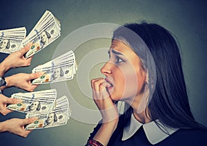 Anxious woman looking at money dollars offered by suspicious people photo
