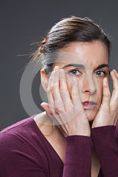 Anxious young brunette woman looking sad