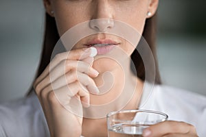 Anxious young woman feel unwell taking pill