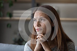 Anxious young woman look in distance pondering of problems