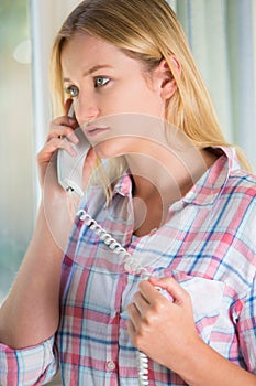 Anxious Young Woman Phoning Helpline