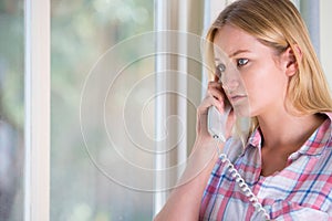 Anxious Young Woman Phoning Helpline