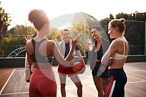 Any suggestions on how we can win. a diverse group of friends getting ready to play a game of basketball together during