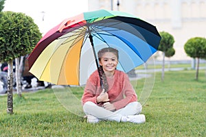 Any weather is good. Rainbow after rain. Multicolored umbrella for little happy girl. Positive mood in autumn weather