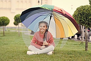 Any weather is good. Rainbow after rain. Multicolored umbrella for little happy girl. Positive mood in autumn weather
