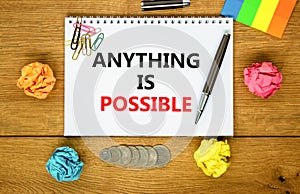Anything is possible symbol. Concept words Anything is possible on beautiful white note. Beautiful wooden background. Black pen.
