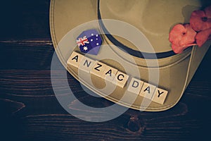 Anzac army slouch hat with Australian Flag on vintage wood background