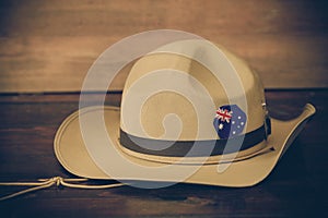 Anzac army slouch hat with Australian Flag on vintage wood background