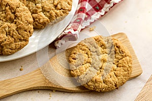 Anzac biscuit on wooden lifter.