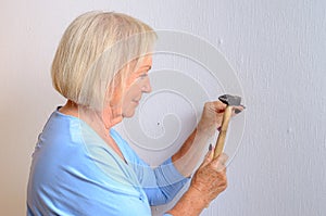 Apable elderly woman doing DIY