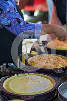 Apam balik is a Southeast Asian fluffy pancake with cream corn and peanuts. This soft pancake is usually made to order on street