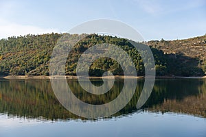 Apartadura dam nature landscape with reflection on the still water in Sao Mamede, Alentejo, Portugal