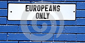 Apartheid sign europeans only blue brick wall