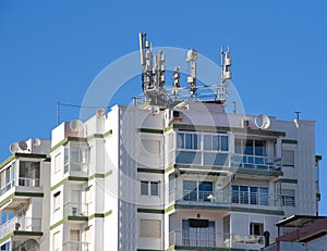 Apartment block, with radio, antennae and mobile masts.