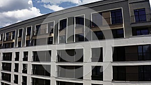 Apartment blocks with balconies. Stock footage. Aerial view of an apartment building on a blue cloudy sky background. photo