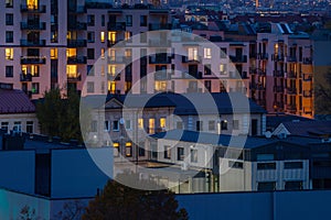 Apartment blocks in the sleeping district at night time. Urban aerial cityscape at dusk, rising electricity prices