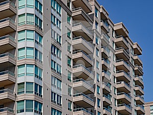 Apartment building with balconies and green tinted windows