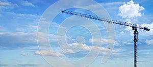 Apartment building construction concept and residential renovation. Copy panoramic area. Construction crane working on building