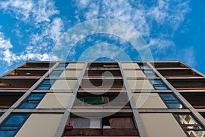 The apartment building on the edge of the road under a blue sky