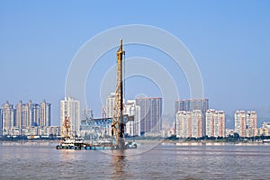 Apartment building with river view and industrial maritime equipment, Wenzhou, Zhejiang Province, China