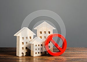 Apartment buildings and red prohibition symbol NO. Emergency and unsuitable for living building. Unavailable expensive housing.