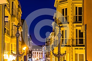 Apartment buildings with small balconies in the city of Blankenberge, Belgium, lighted belgian architecture by night