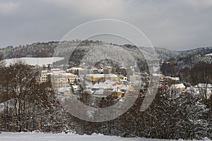 Apartment buildings and textile factory on in small town, winter morning, after snow falling