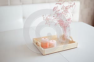 Apartment or condominium Dining room, dining table decorated with cadles and vase with pink dried flowers