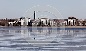 Apartment houses on a shore of a lake in spring