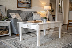 White table and grey settee in apartment interior