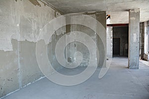 Apartment renovation of a newly built house with concrete floor, finishing on walls, and a concrete column, or pillar