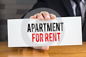 Apartment for rent, message on white card and hold by