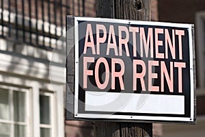 Apartment for rent sign in an urban setting