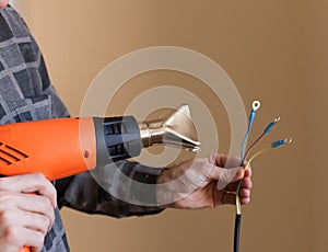 Apartment-repair. Hands, wire, electric drier, close up