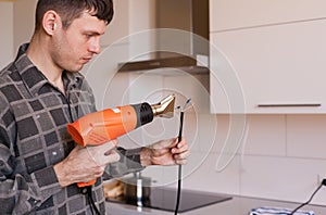 Apartment-repair. Man, wire, electric drier, close up