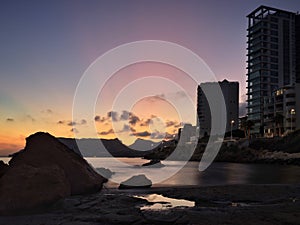 Apartment tower on quiet and beach at sunset