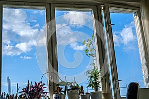 apartment windows against blye sky and dirty glass photo