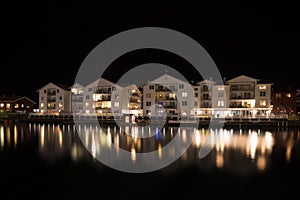 Apartments reflected in the water at night