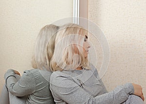 An apathetic woman sits at the mirror
