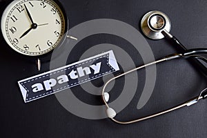 Apathy on the paper with Healthcare Concept Inspiration. alarm clock, Black stethoscope.