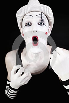 Ape mime in striped gloves and white hat