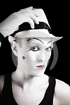 Ape mime in striped gloves and white hat